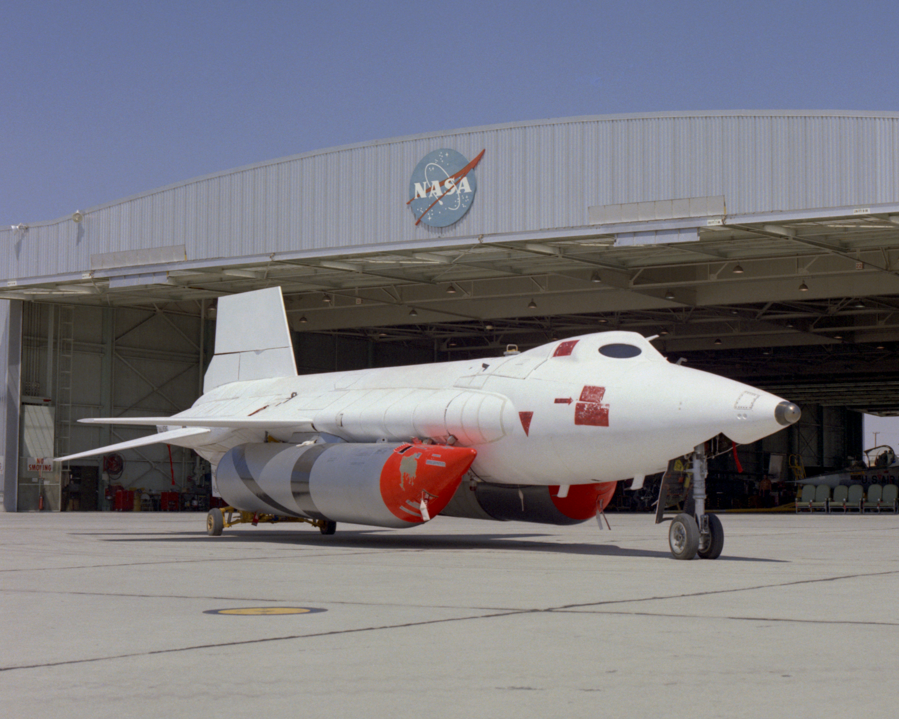 White-coated X-15A-2 with external tanks parked in front of a hangar.